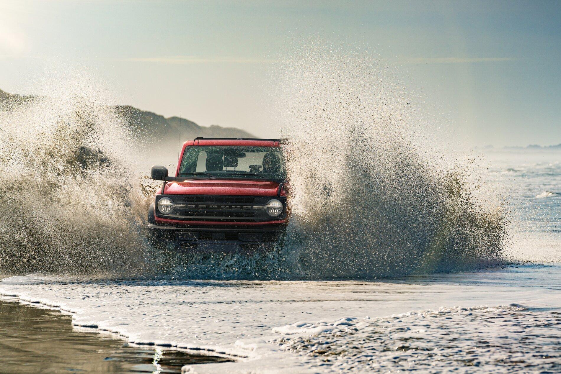 Ford Bronco Lucid Red Pearl thread u725_fna_shot_080_49895_ext_running_beach_splash_whiskey_run