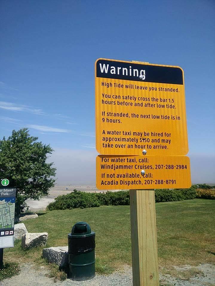 Ford Bronco Bronco submerged in water during Maine high tide bar-island-warning-sign