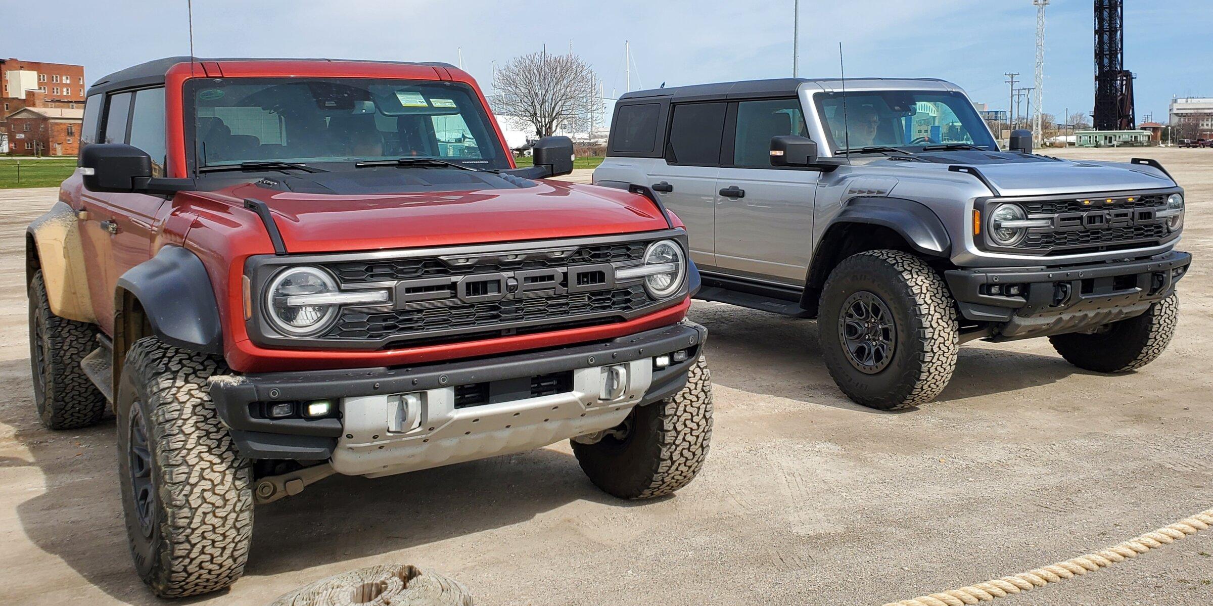 Ford Bronco 2 raptors in Port Huron today - Iconic Silver & Hot Pepper Red 20220430_102933