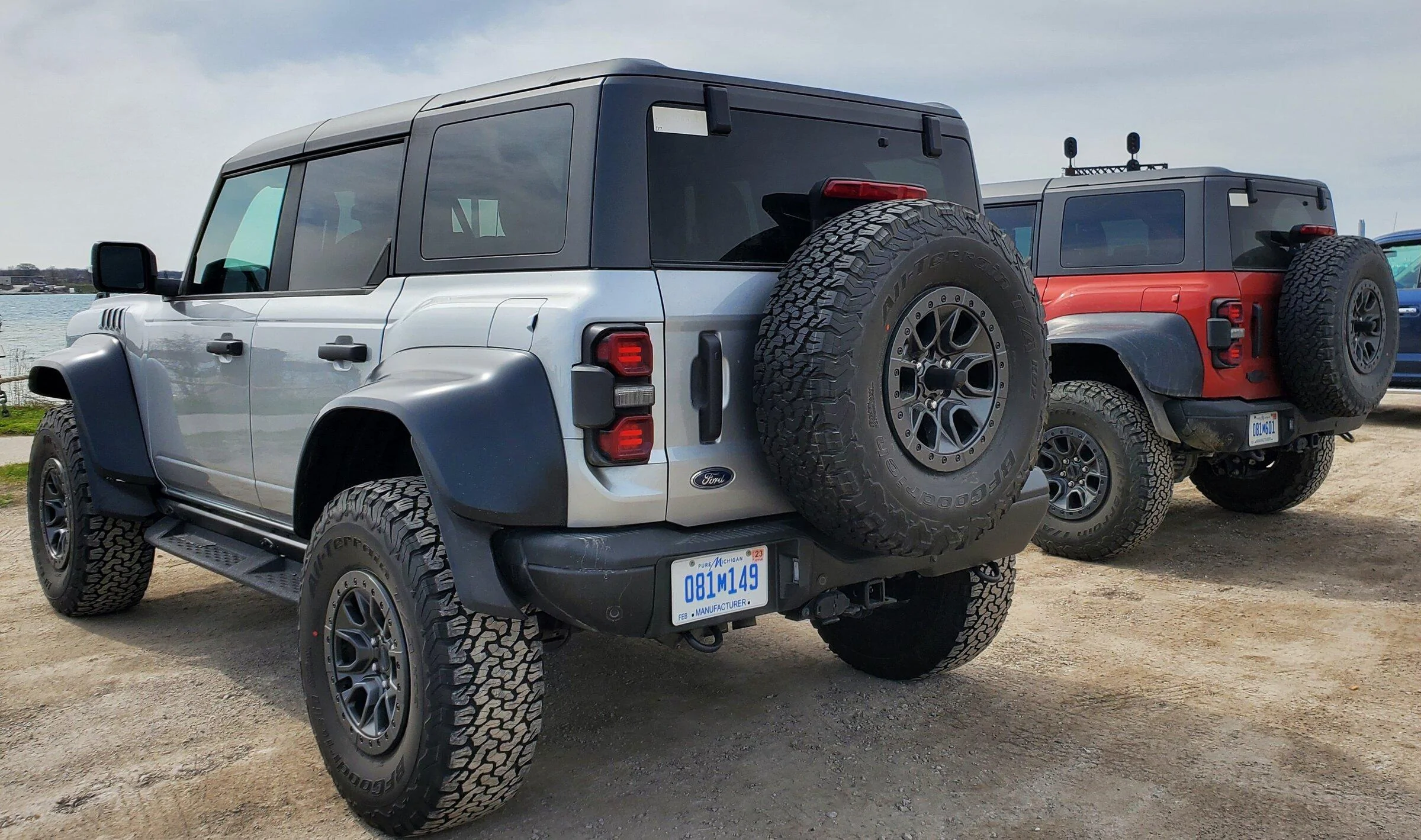 Ford Bronco 2 raptors in Port Huron today - Iconic Silver & Hot Pepper Red 20220430_103939