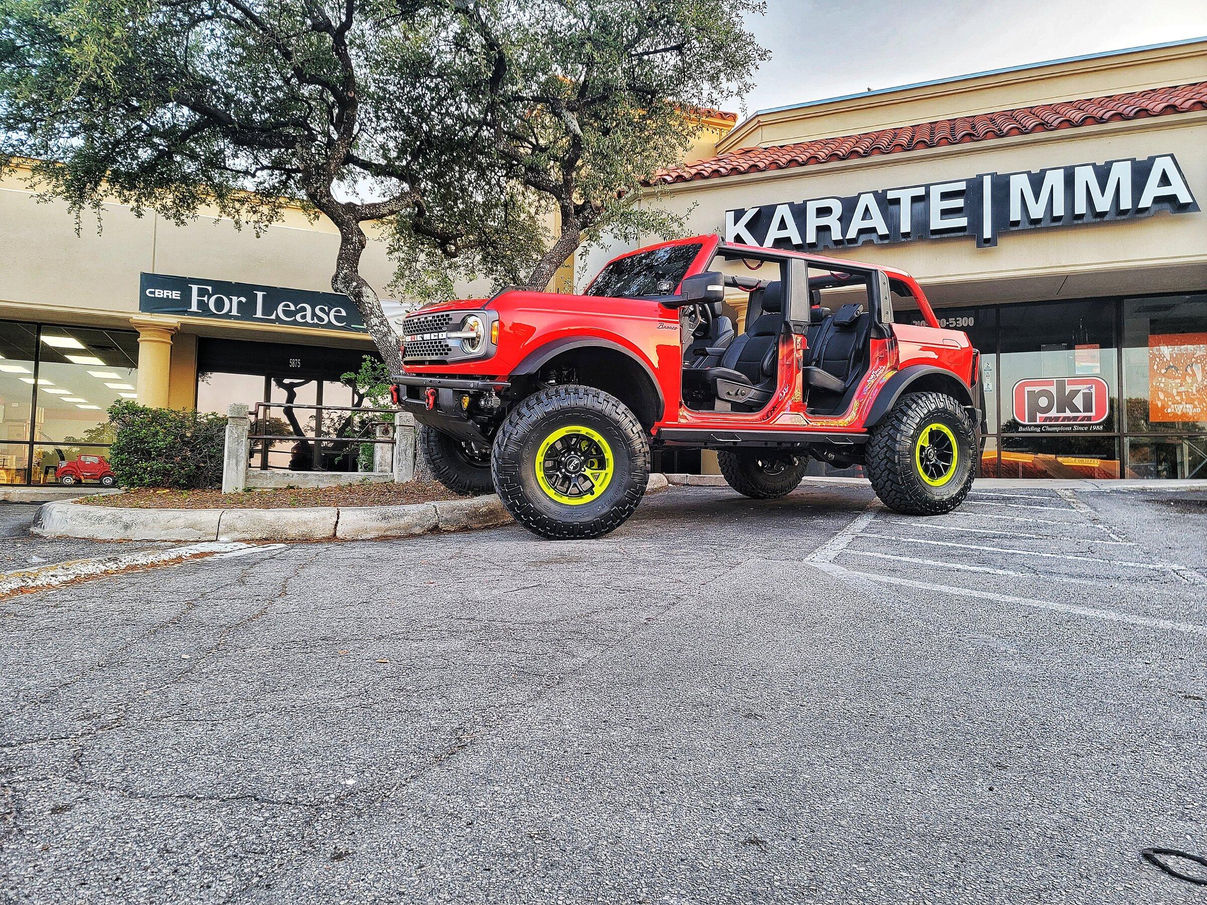 Ford Bronco My Badlands Race Red on 38's, 17" RTR wheels, 4.5" custom lift, custom steps & graffiti 20220515_070720-01