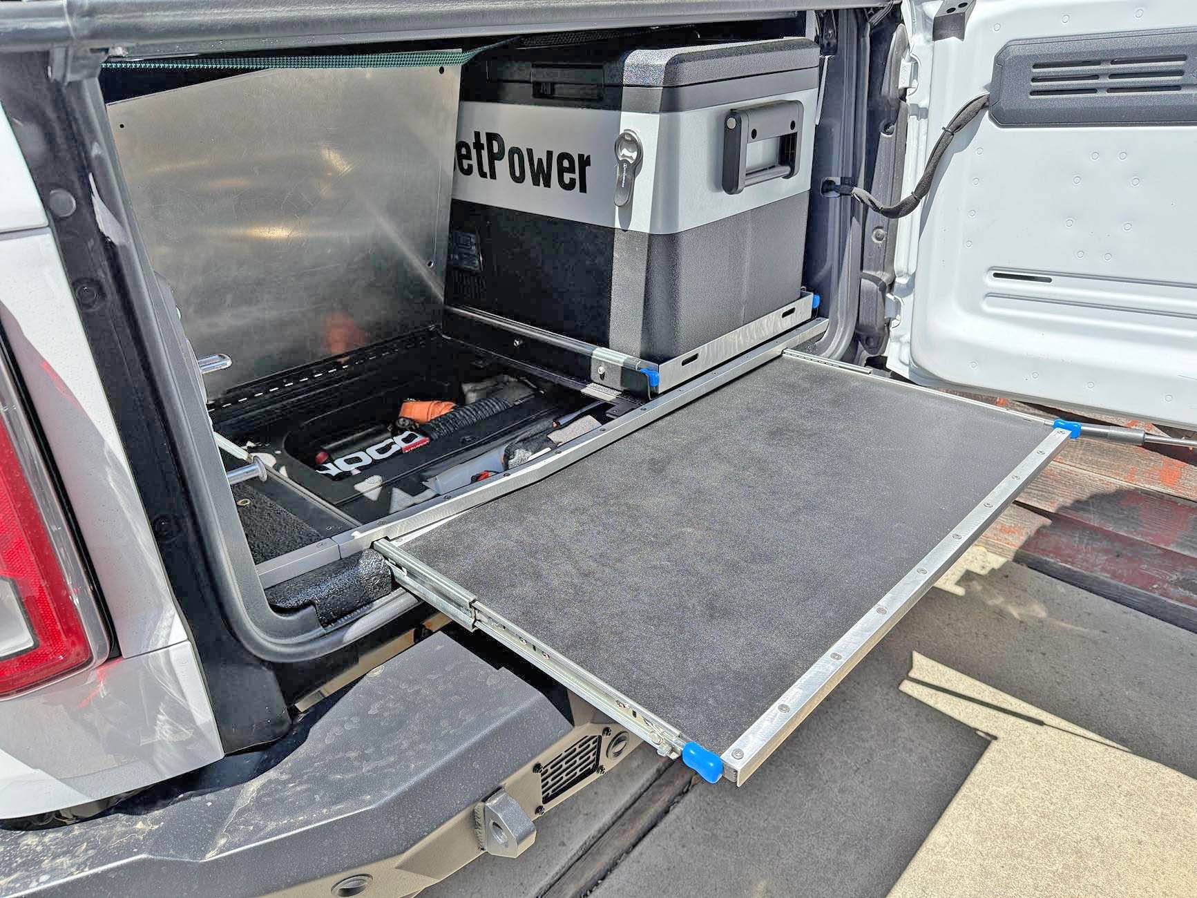 Ford Bronco Slide out table, refrigerator tray & jack block stash - custom cargo build. I need to stop watching Contraband: Seized at the Boarder. IMG_8686