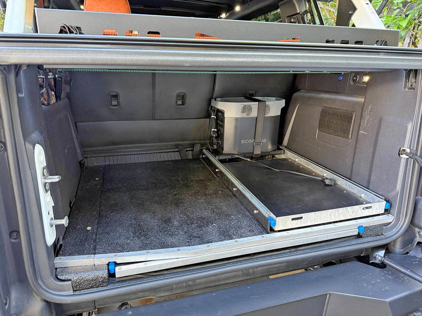 Ford Bronco Slide out table, refrigerator tray & jack block stash - custom cargo build. I need to stop watching Contraband: Seized at the Boarder. IMG_8707