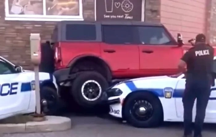 Man driving Bronco tries to drive over police cars (updated w/ news article story)
