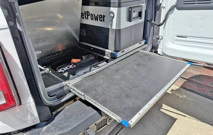 Slide out table, refrigerator tray & jack block stash - custom cargo build. I need to stop watching Contraband: Seized at the Boarder.