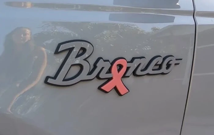 Custom Bronco badging for cancer survivor presented to wife