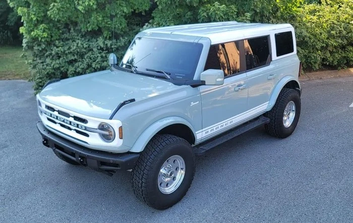 Retro Build Outerbanks Bronco featuring white roof, grill, stripes