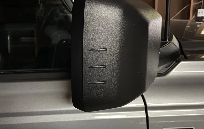 Redesigned mirror caps with whistle reducing / eliminating strakes -- implemented by Mirror Whistling Fix TSB