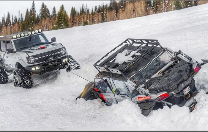 Bronco on tracks snow rescues stuck UTV