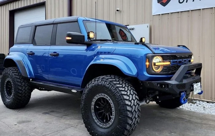 Velocity Blue Bronco Raptor on RPG perch collar lift, 38's and painted flares